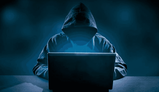 "Obligatory hacker in a hoodie at keyboard"